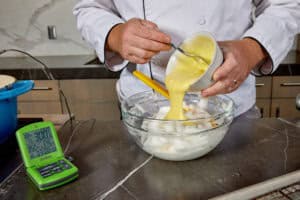 adding yolk mixture to whites