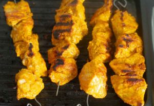 Skewered chicken on a grill