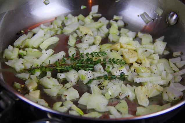 Diced onion, garlic, thyme and black pepper. heating in a saucepan on the stove