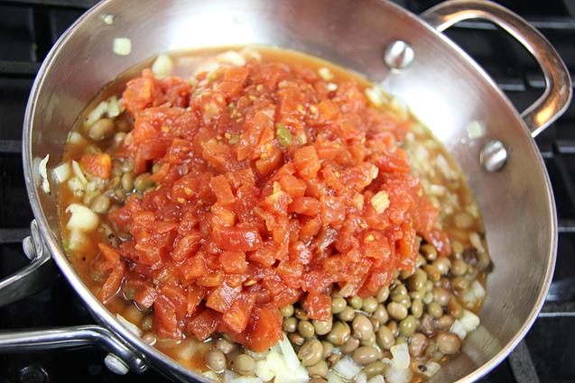 Stewed tomatoes added to pan