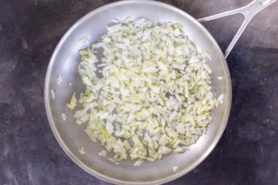 Onions sautéing in a pan.