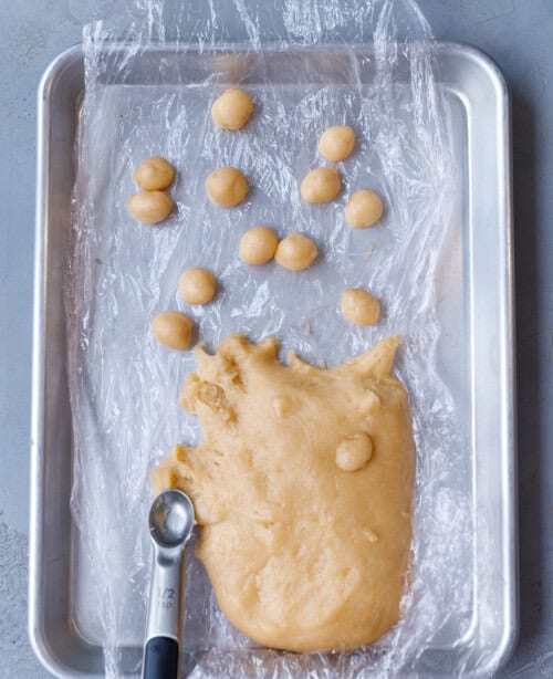 Walnut shaped cookie dough shaped into cherry sized balls
