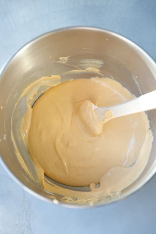A metal KitchenAid mixer bowl with Dulce De Leche Buttercream