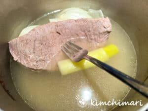 beef brisket cooked in pot with broth