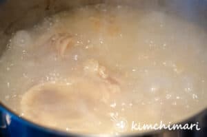 milky white bone broth seolleongtang in pot boiling