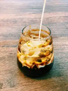 Adding Milk into A Glass swirled with Brown Sugar Syrup and Brown Sugar Boba for Boba Milk Tea