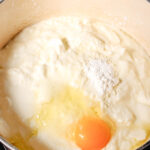 yogurt, a raw egg, and cornstarch in a dutch oven