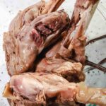lamb shanks that have been pressure cooked placed inside a glass bowl