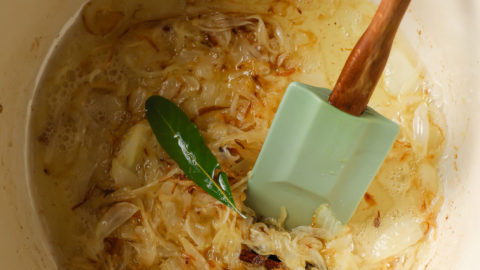 Browned onions with whole spices in a Dutch oven