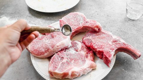 seasoning pork chops before cooking in a crockpot